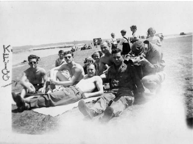 Kenneth Figg with company. Figg is wearing sunglasses and smoking  on the extreme left of the shot. 